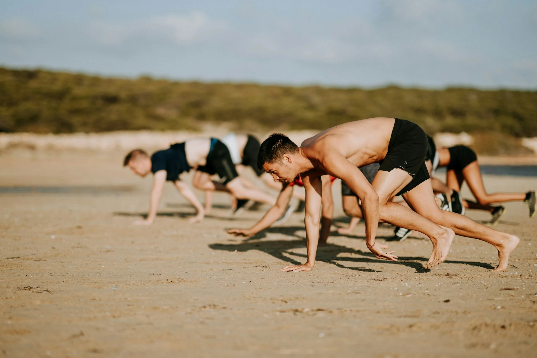 A group training together on a beach