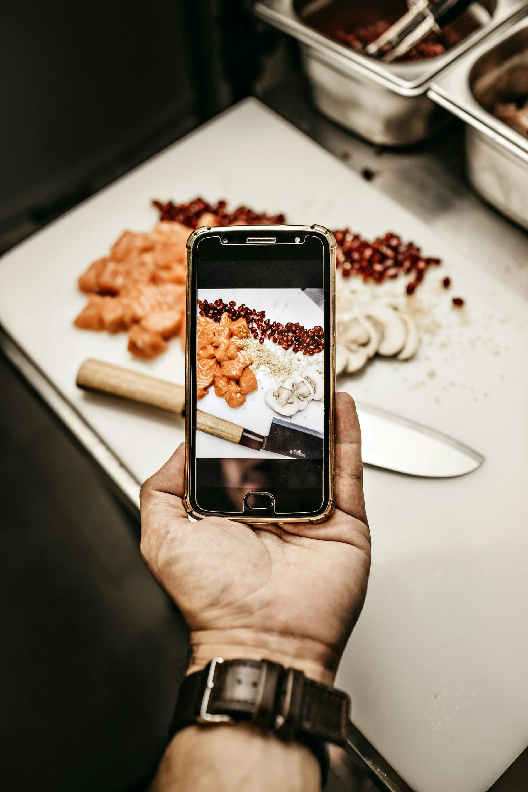 A person photographing food with a phone