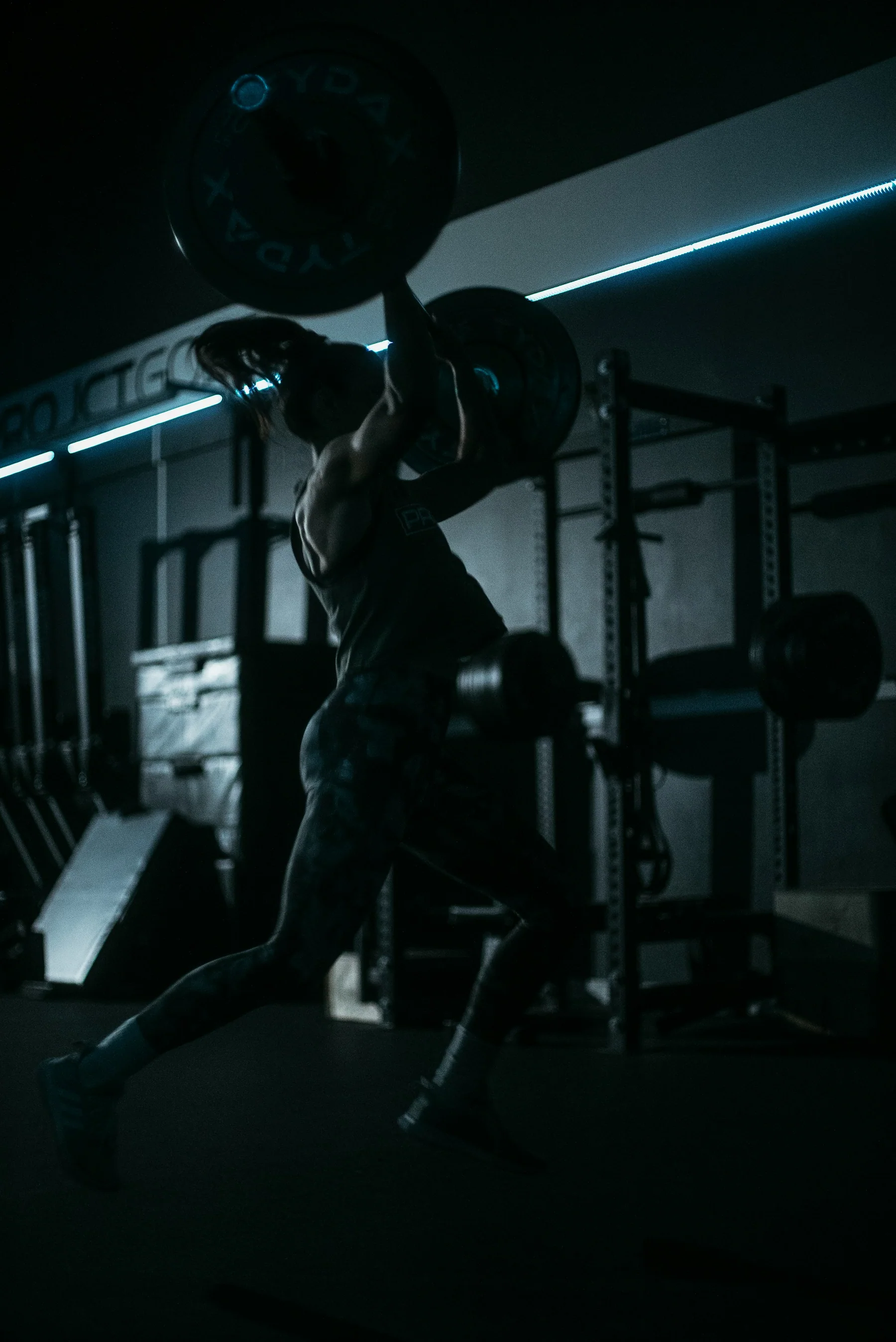 An athlete strength training in a dark gym